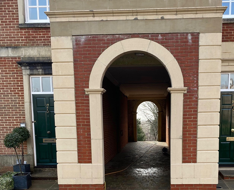 textured paving stones in red yellow and brown colors with grass peeking through showcasing wear patterns and showing six distinct shapes