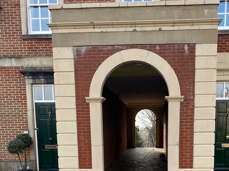 patio area with natural stone paving and green plants in pots outside a wooden door with large windows ideal for outdoor spaces 3 design elements