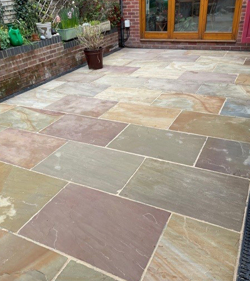 stone patio with various colored tiles and a potted plant in a garden setting ideal for outdoor spaces 2 colors 2 styles