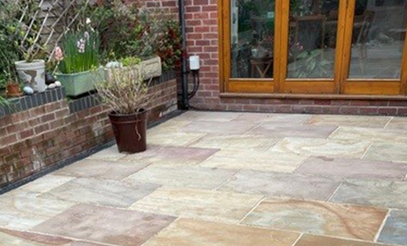 arched entranceway leading to a walkway with brick walls and green doors number 19 and 20 showcasing architectural details and a pathway hinting at number 13 nearby